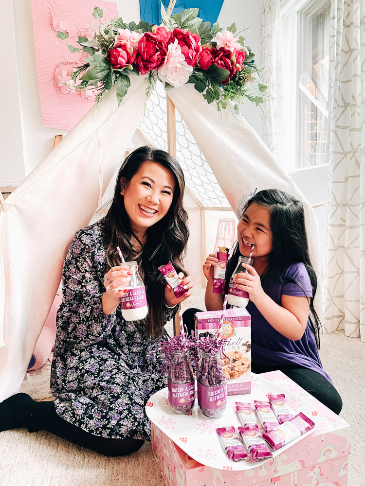 Mom and daughter snack time in tent