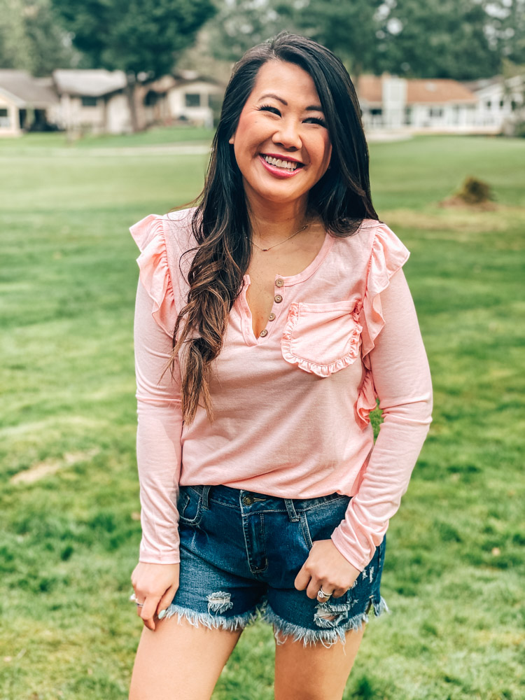 girl wearing pink top and jean shorts